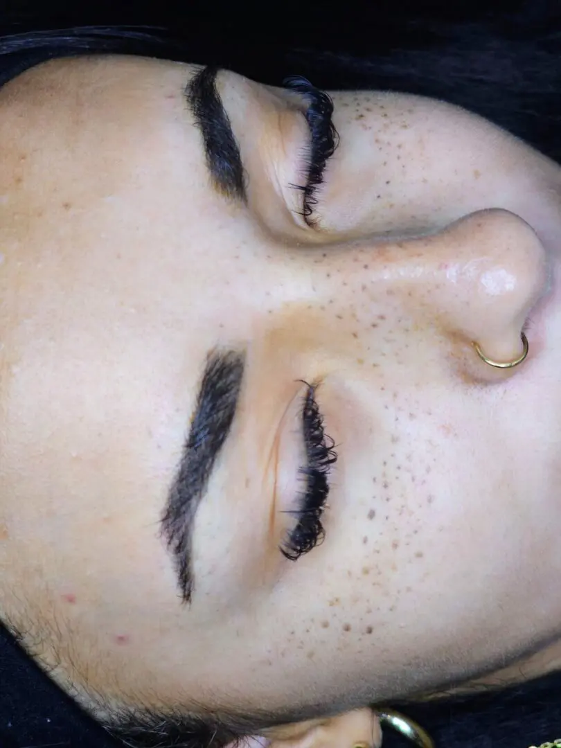 Close-up freckled face with nose ring